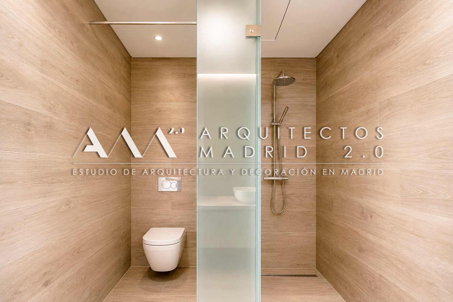Ducha con revestimiento cálido y mampara de vidrio en Casa Heinz vivienda unifamiliar en Madrid
