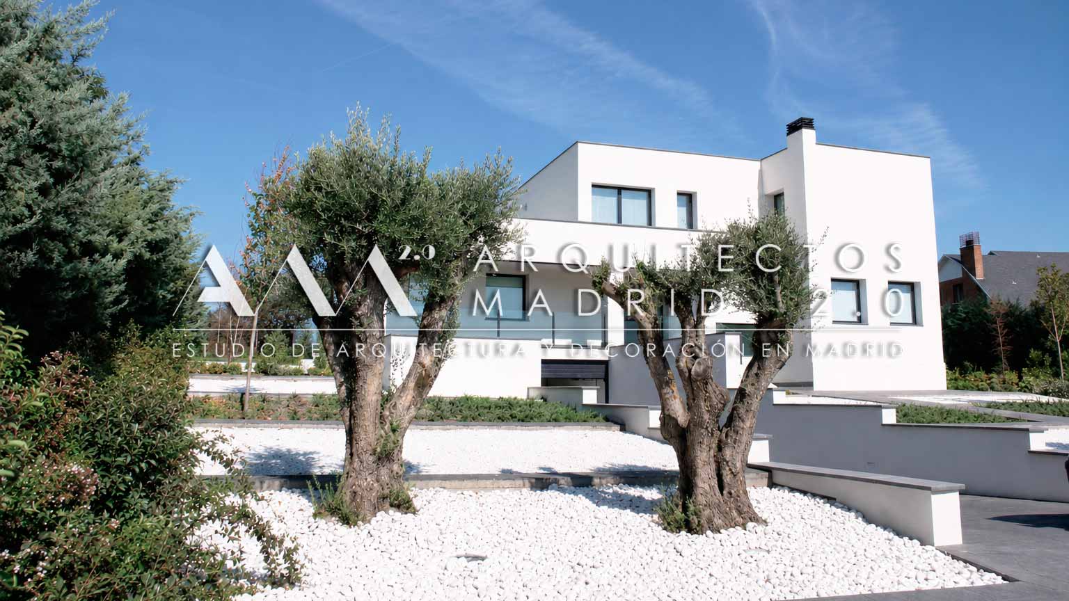 Fachada moderna de vivienda unifamiliar con olivos y jardín